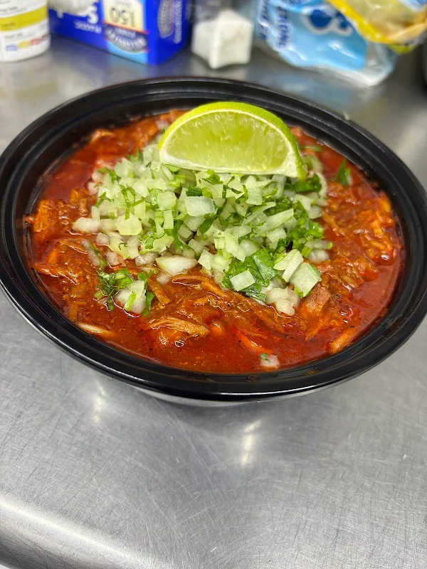Birria ramen with lime, onion, cilantro, and salsa